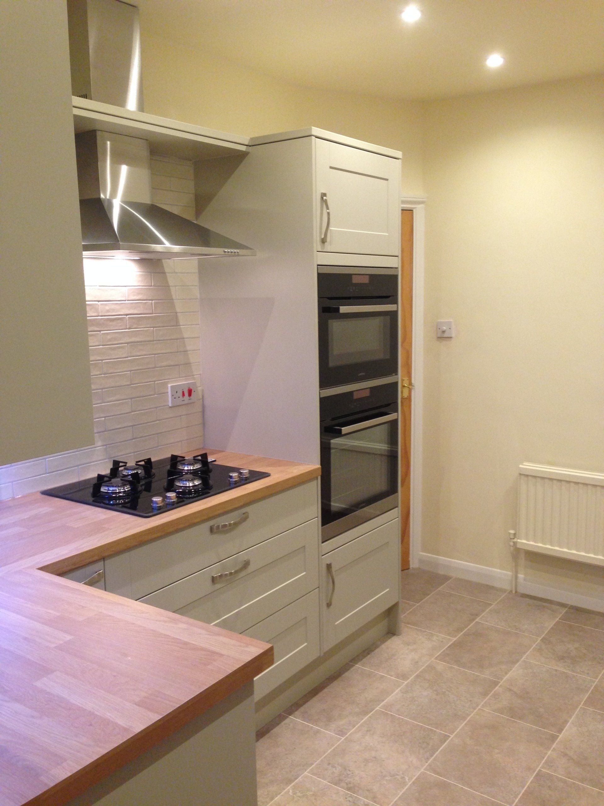 new kitchen with white metro tiles and gas built in hob