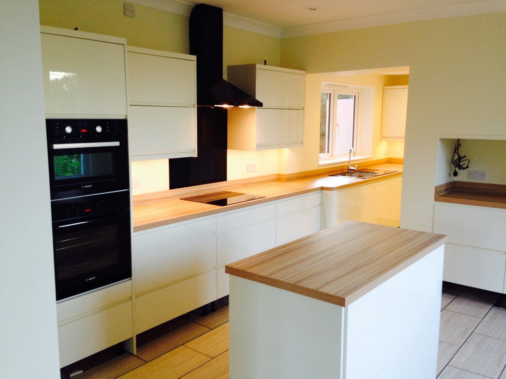 sleek new white kitchen with handleless units