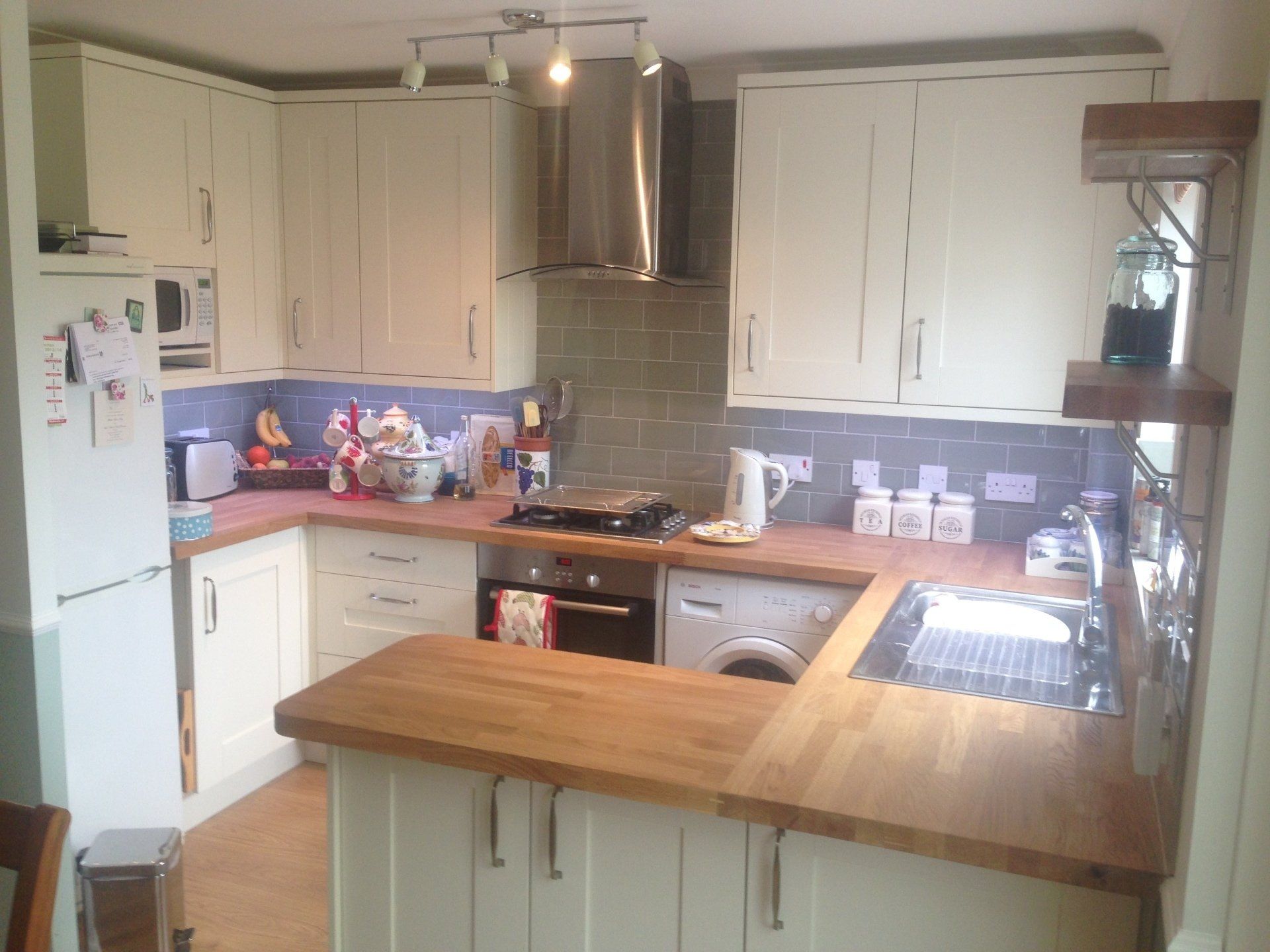 pretty shaker style kitchen with brushed steel extractor