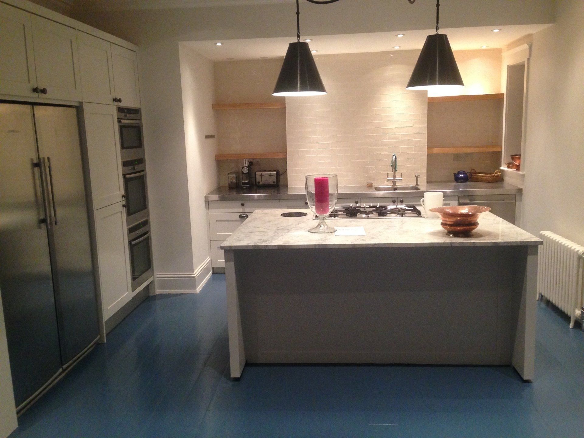 farmhouse style kitchen with sleek new units and feature lights