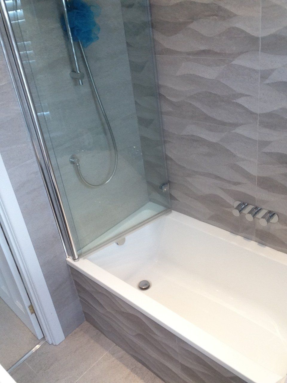 new bath with shower and glass screen