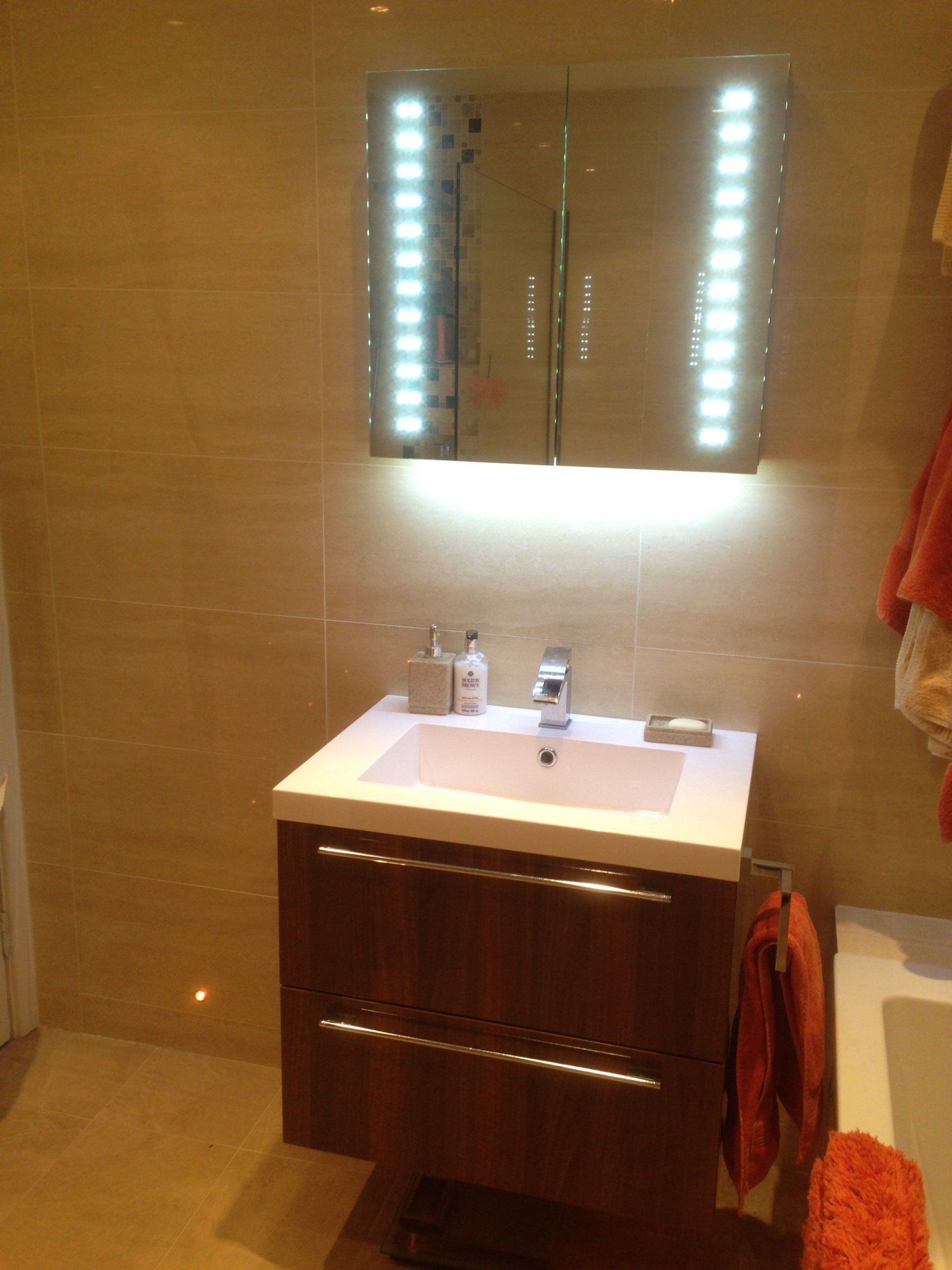 illuminated mirror above new floating sink