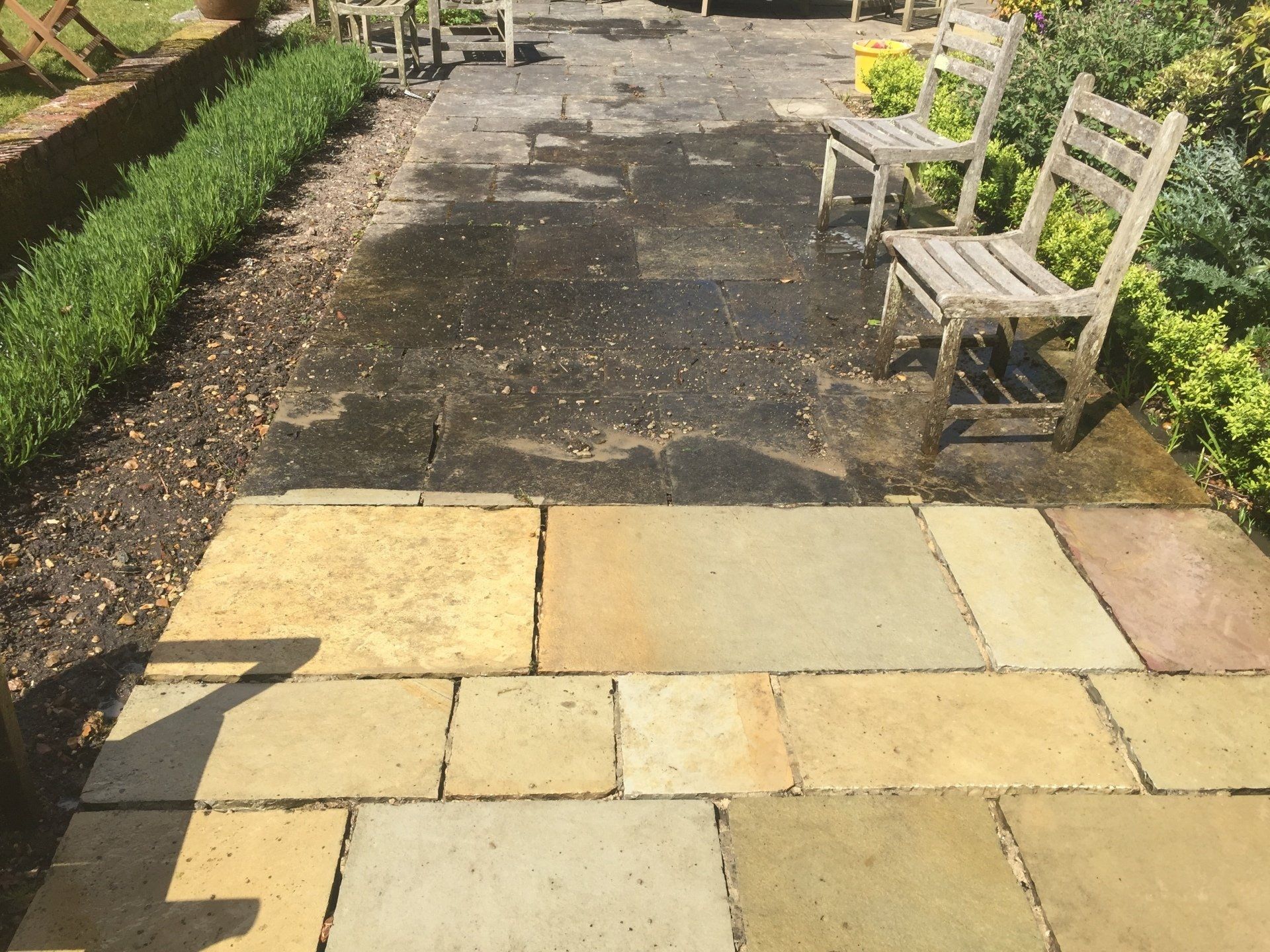 old grey slabs in garden half cleaned
