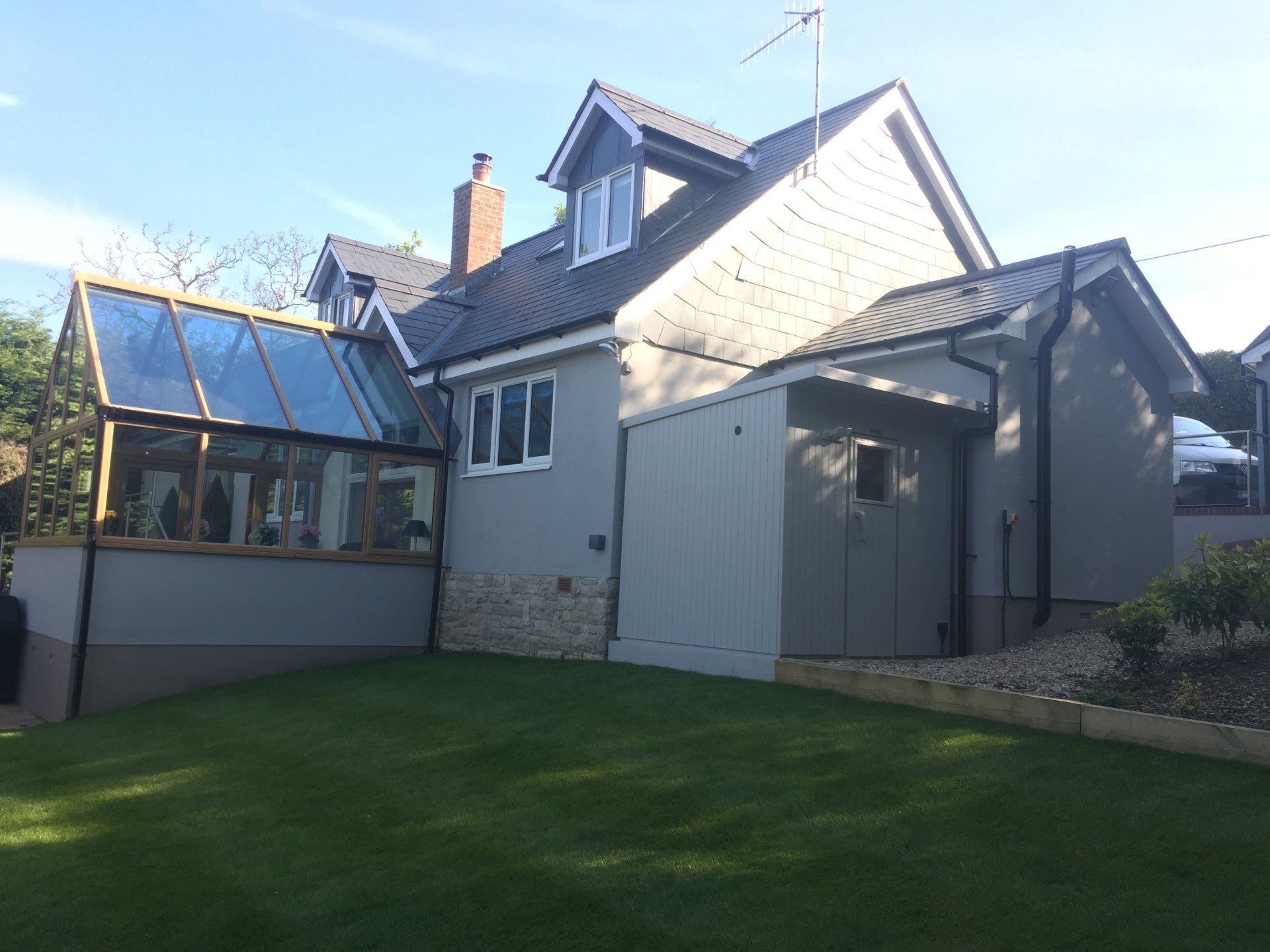 large hom from rear with garden room and outdoor shower