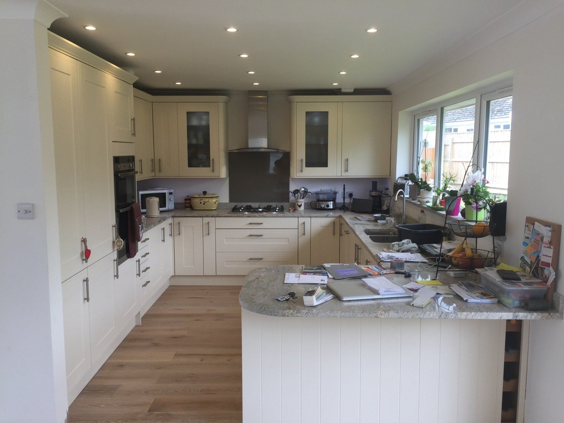 big new cream shaker style kitchen with grey marble worktops before flooring