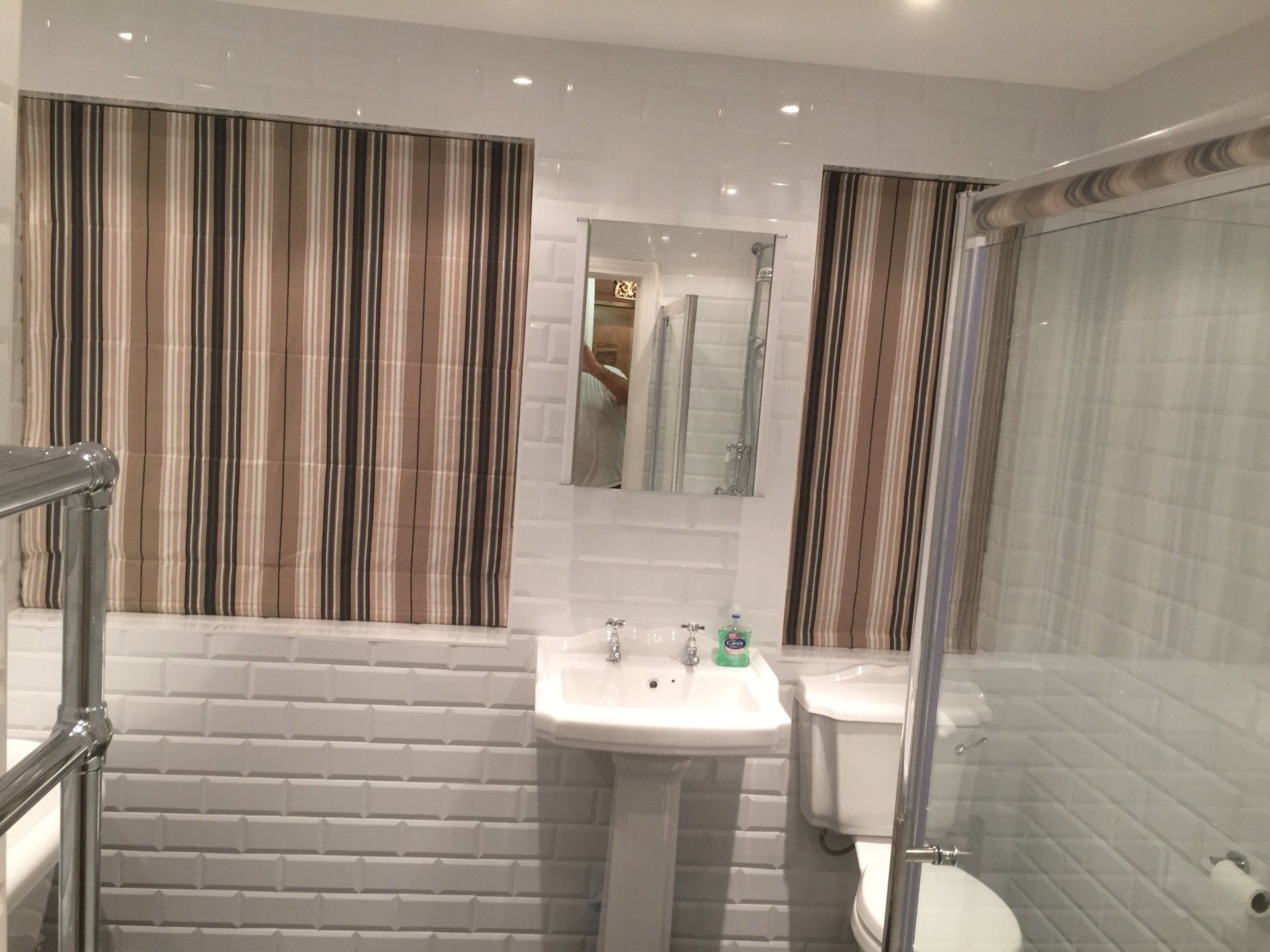 white bathroom with striped blinds