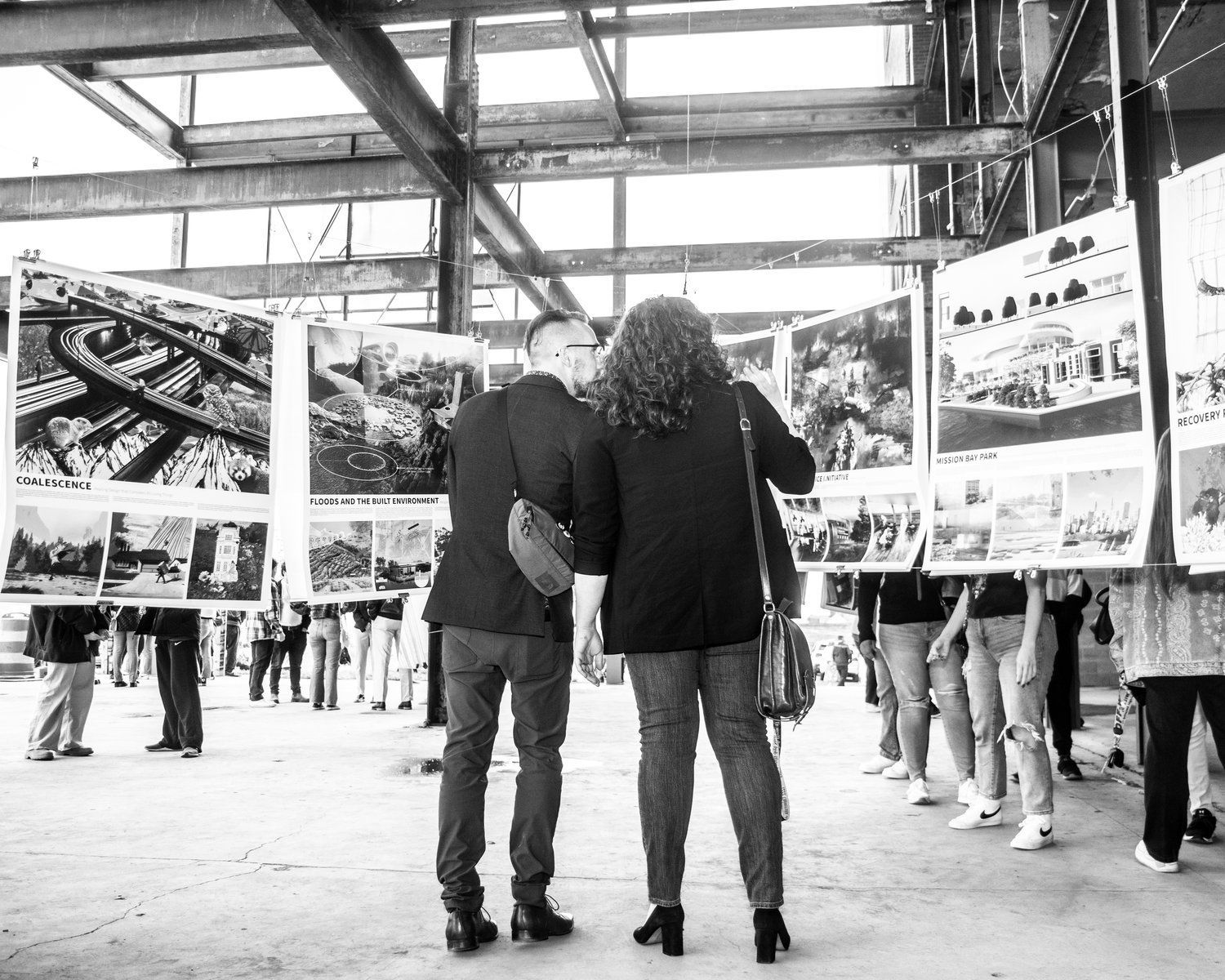 A man and a woman are looking at pictures in a museum.