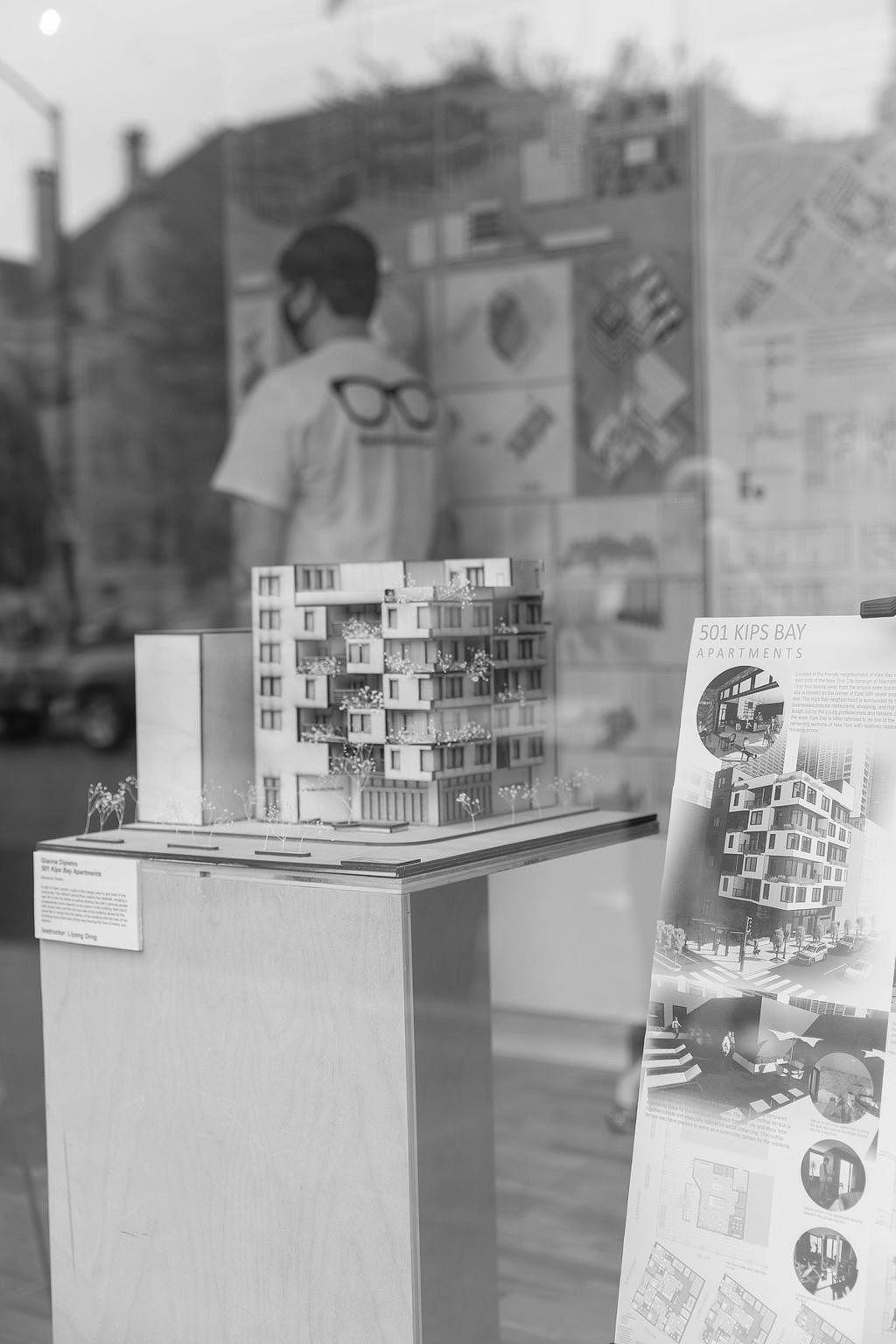 A black and white photo of a model of a building on display.