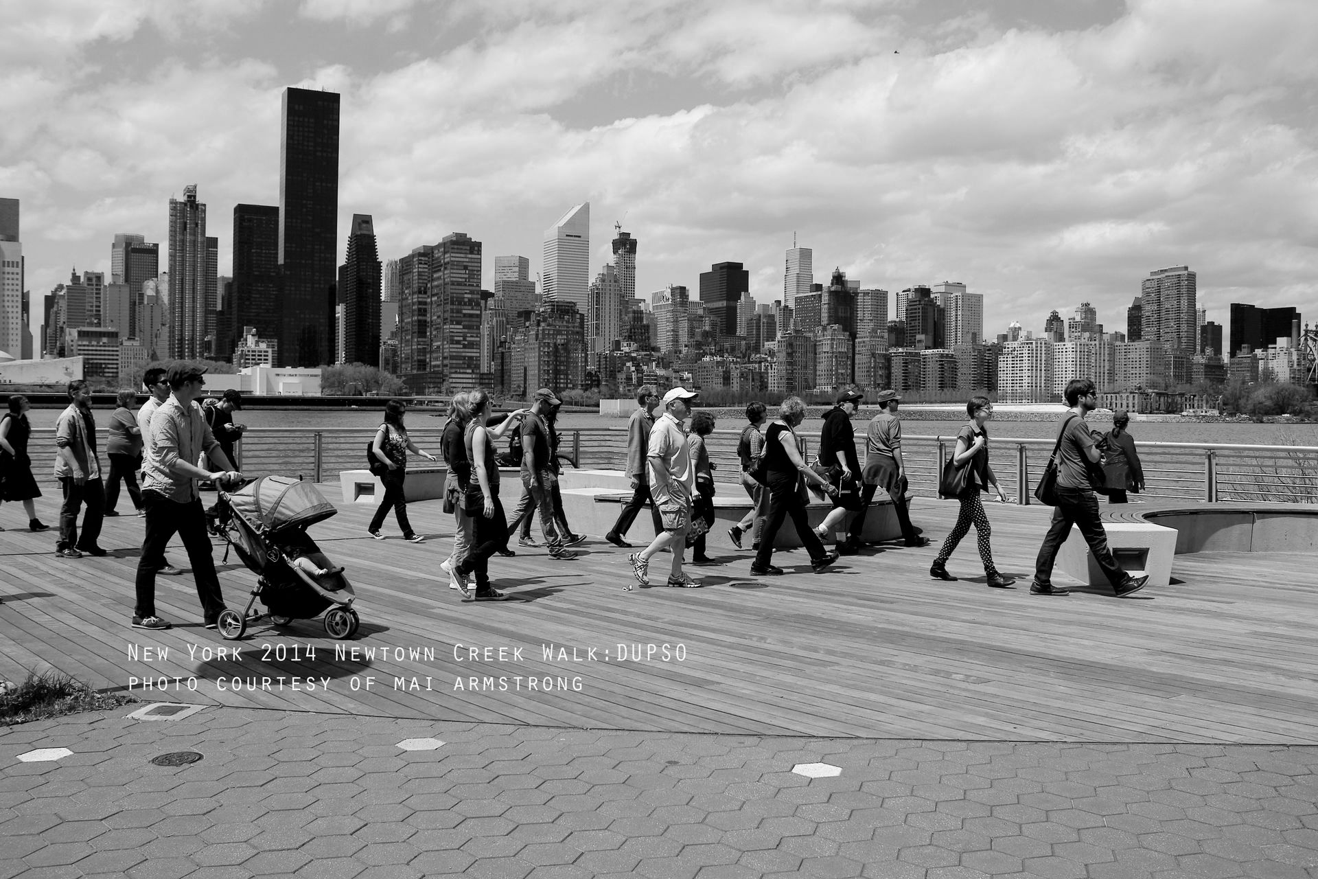 A black and white photo of people walking in a city