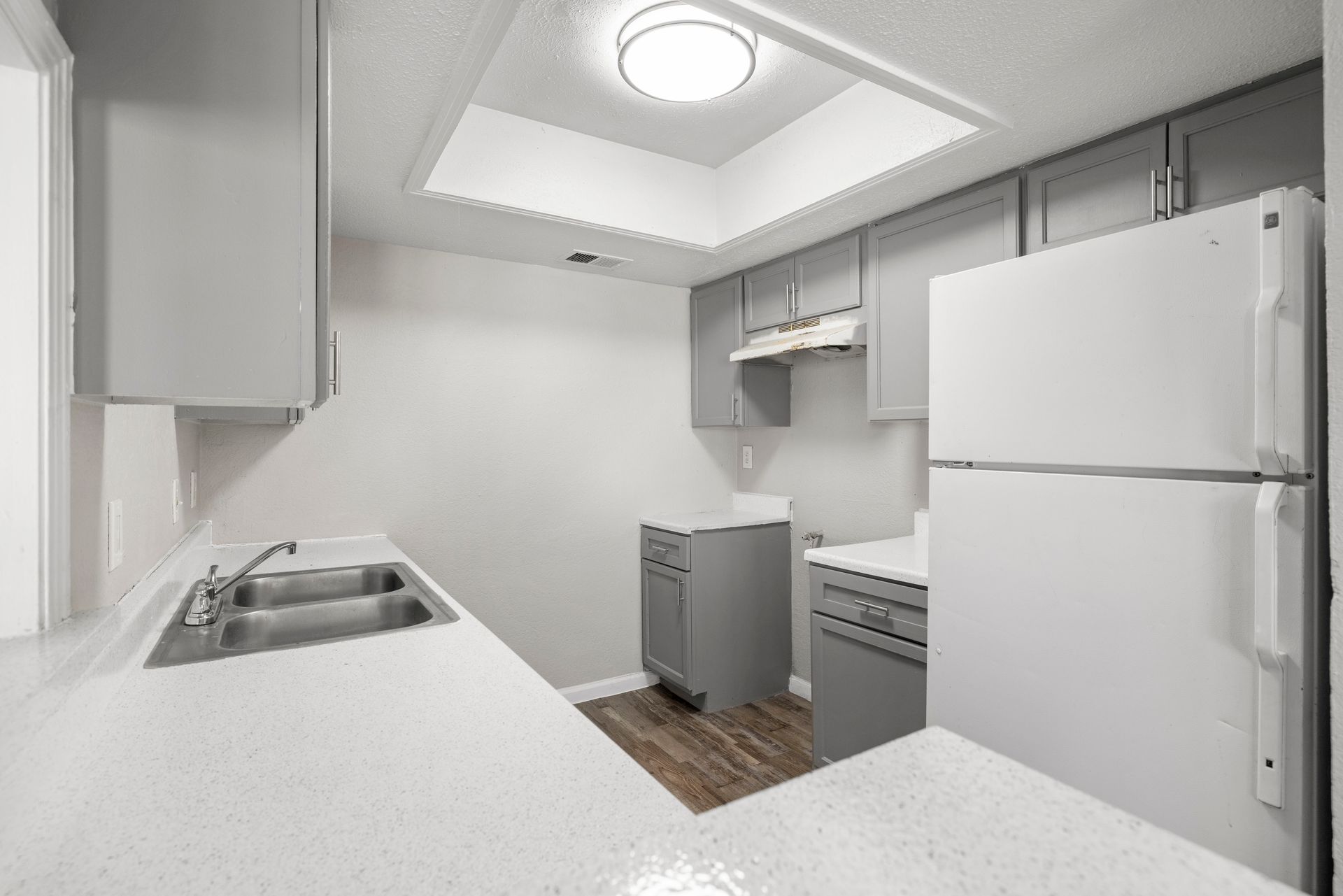 A kitchen with a stove , refrigerator and sink at Senita Apartment Homes in Dallas, TX!