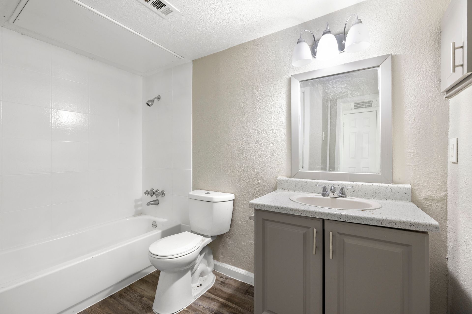 A kitchen with white cabinets , stainless steel appliances , and a large island at Senita in Dallas, TX.