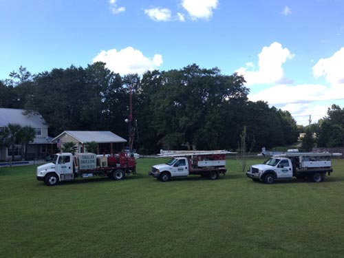 Tree trucks on field - Well Drilling in Silverhill, AL