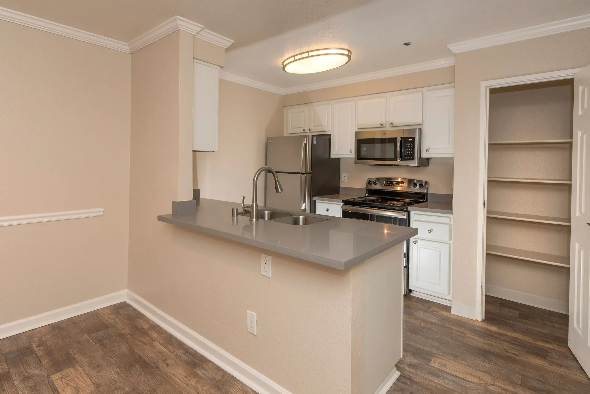 Kitchen with island, stainless-steel appliances, white cabinets