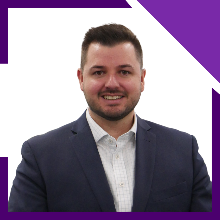 A man in a suit and white shirt is smiling for the camera