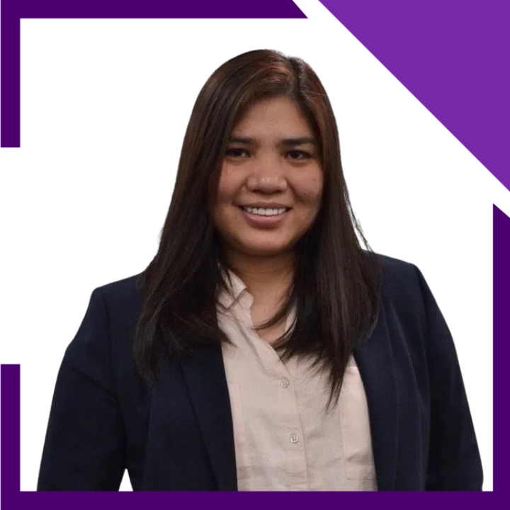 A woman in a suit is smiling in front of a white background