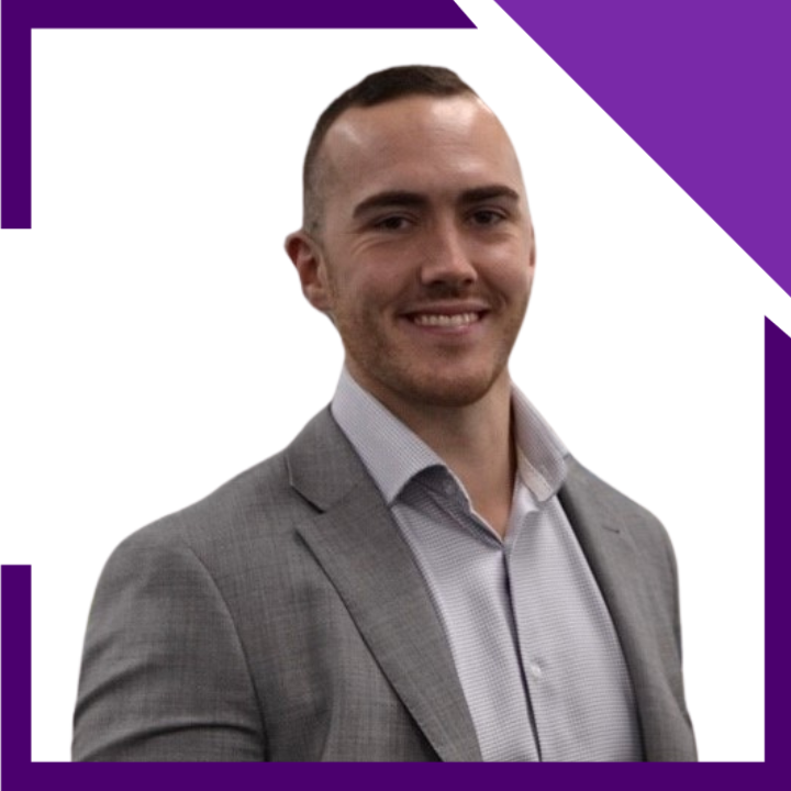 A man in a suit and white shirt is smiling for the camera