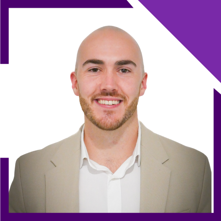 A man in a suit and white shirt is smiling for the camera