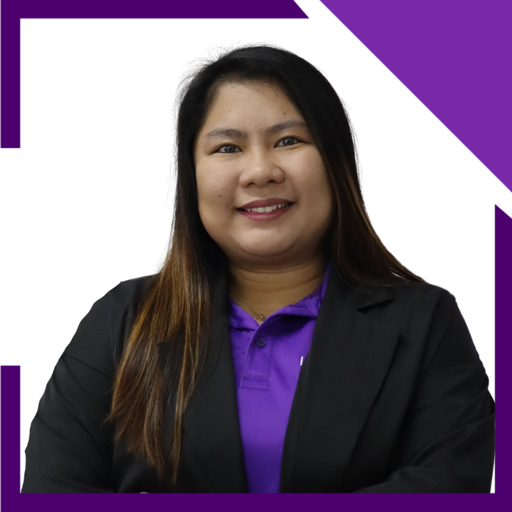 A woman wearing a purple shirt and a black jacket is smiling.