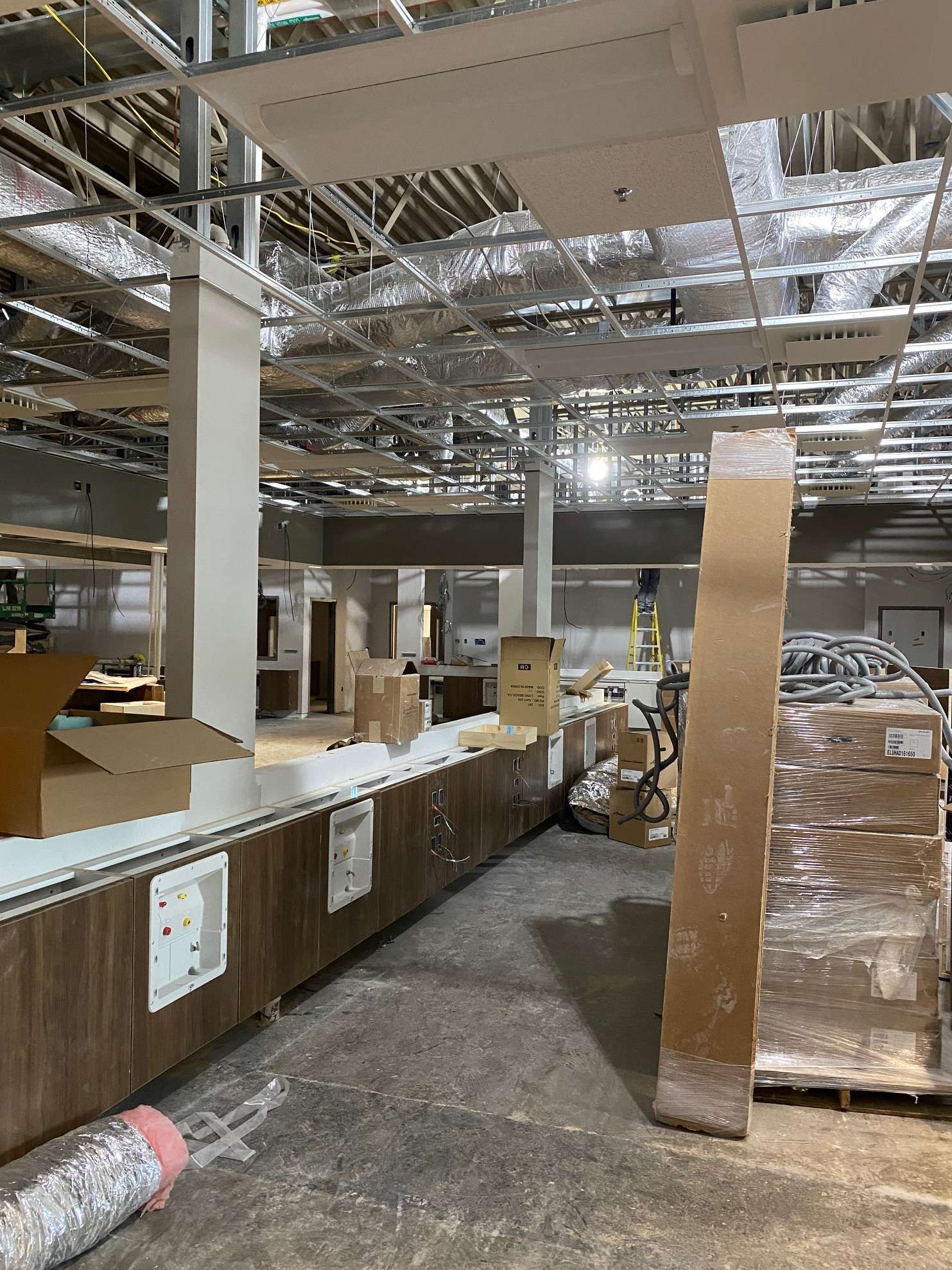 A large warehouse with a lot of boxes on the floor.