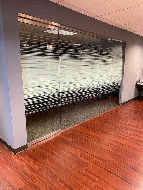 A room with sliding glass doors and a wooden floor.