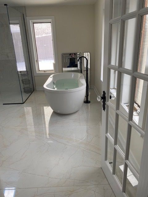 A bathroom with a bathtub and a shower.