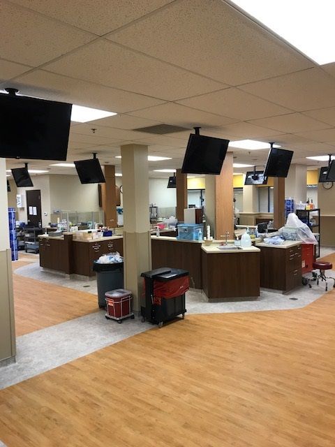 A large room with a lot of televisions on the ceiling