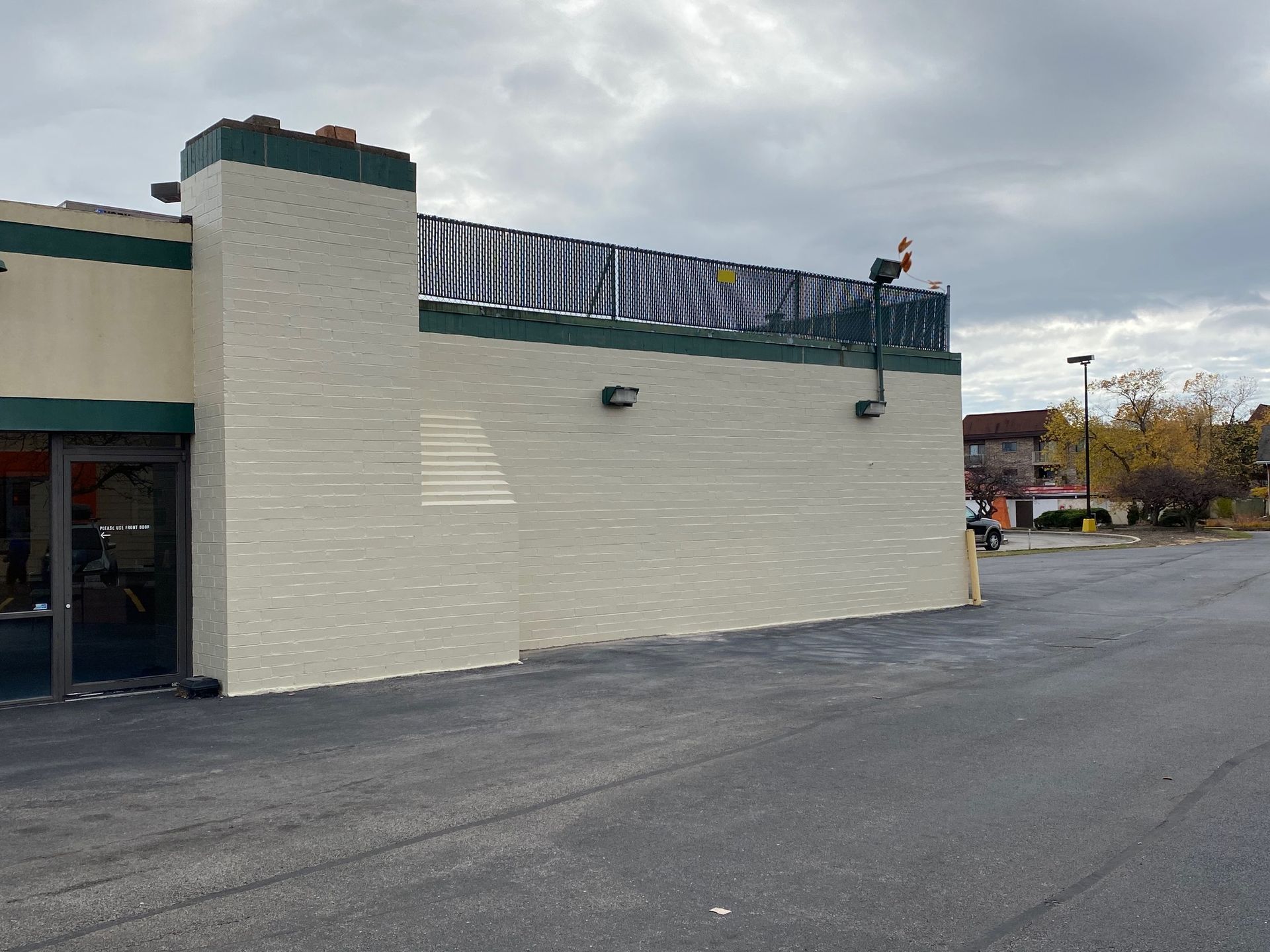 A white brick building with a green trim and a sign on top that says ' diner '
