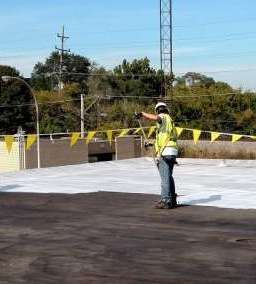 A man is standing on top of a concrete surface.
