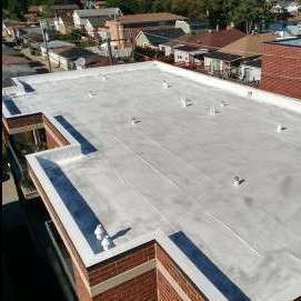 An aerial view of a roof of a building with a flat roof.