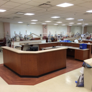 A large room with lots of desks and a clock on the wall