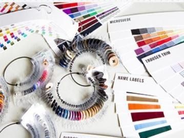 Color swatches and sample cards with circular fan decks of multicolored paint and label strips