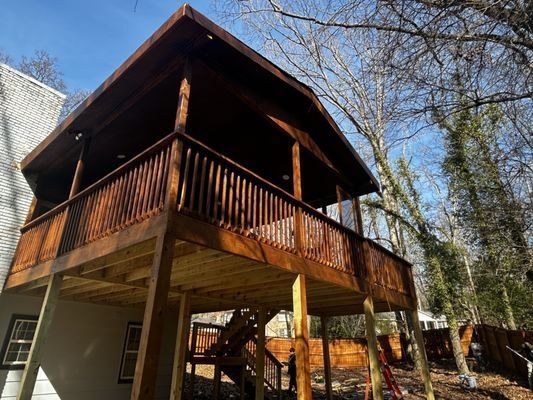 A wooden deck is being built on top of a house.