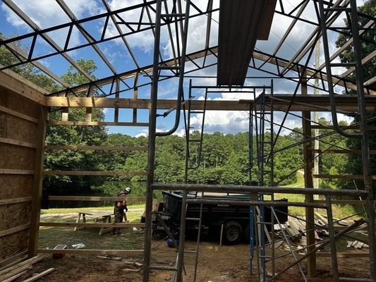 A truck is parked in front of a building under construction.