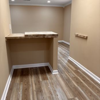 A hallway with hardwood floors and a wooden counter top.