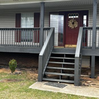 A house with a porch and stairs leading to the front door