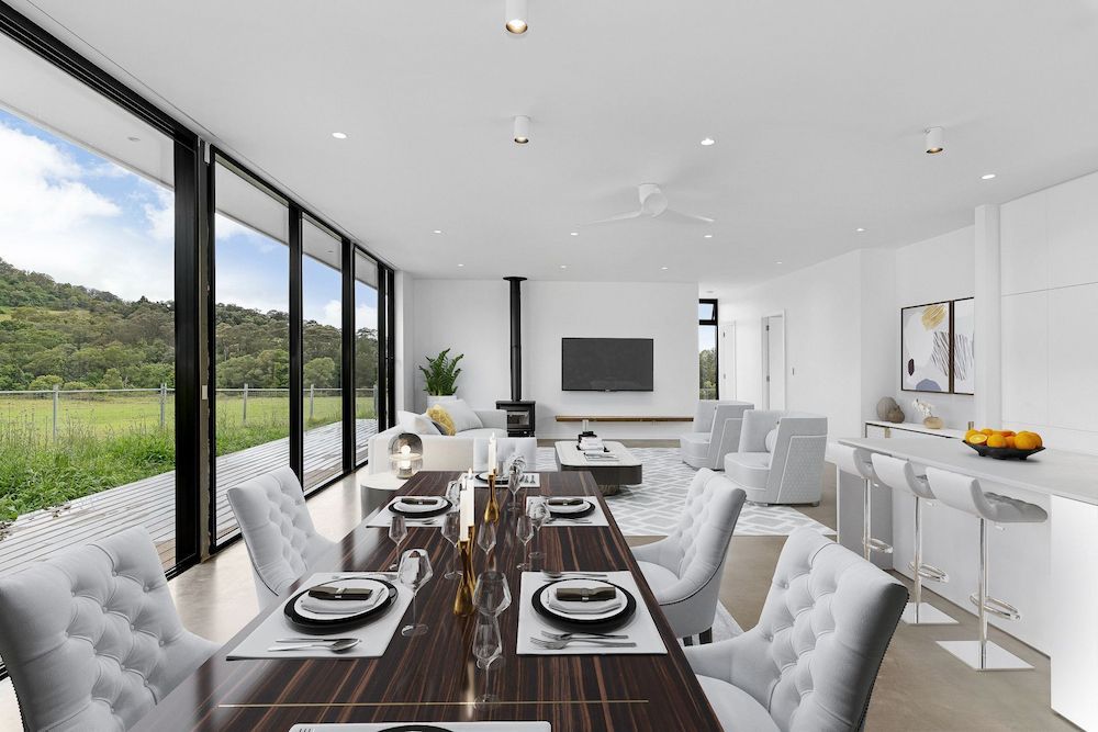 A Dining Room With a Long Table and Chairs and a Large Window — Mylec Electrical Solutions in Shell Cove, NSW