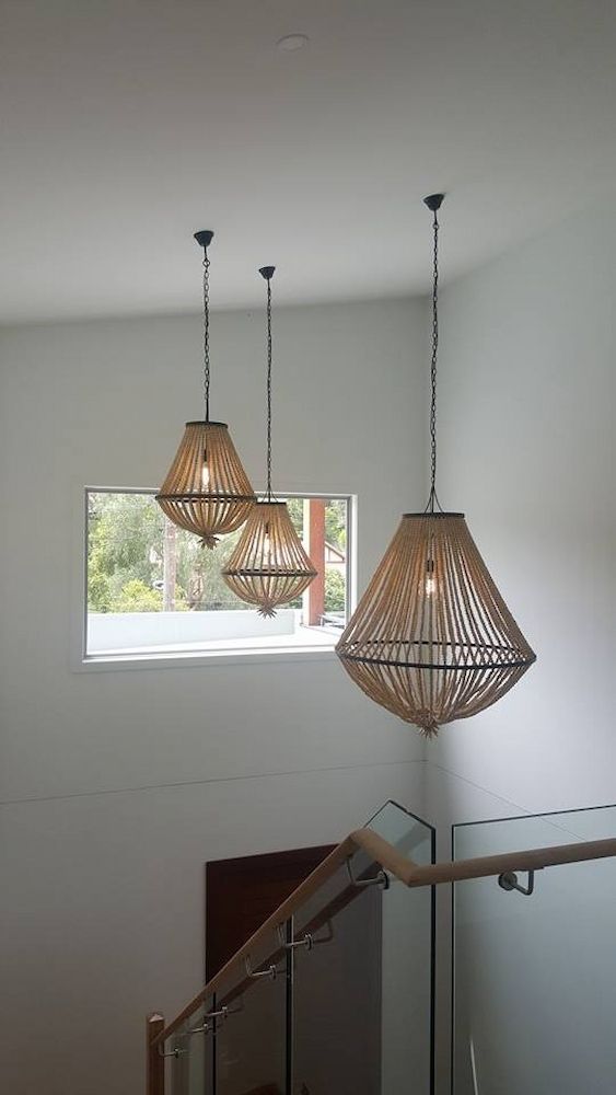 Three Pendant Lights Are Hanging From the Ceiling Above a Staircase — Mylec Electrical Solutions in North Wollongong, NSW