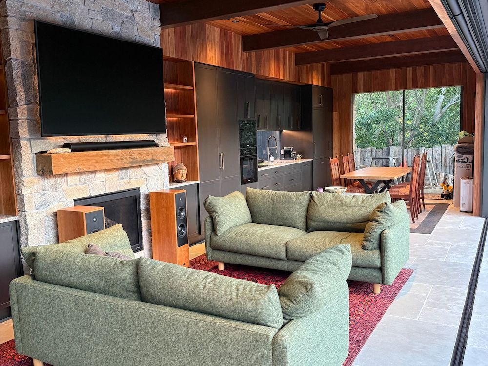 A Living Room Filled With Furniture and a Flat Screen TV — Mylec Electrical Solutions in Shell Cove, NSW
