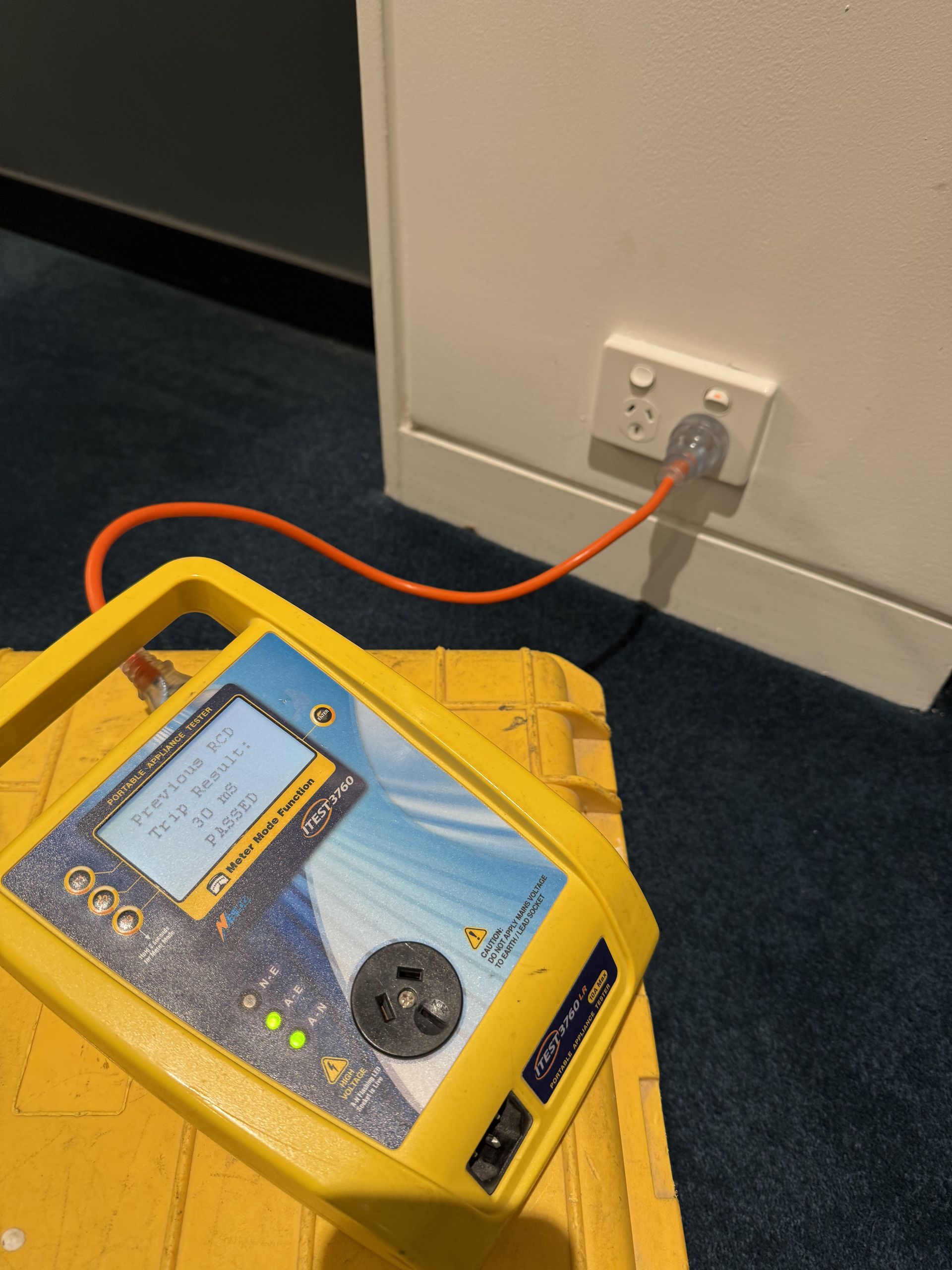A yellow device is plugged into a wall outlet — Mylec Electrical Solutions in Shell Cove, NSW