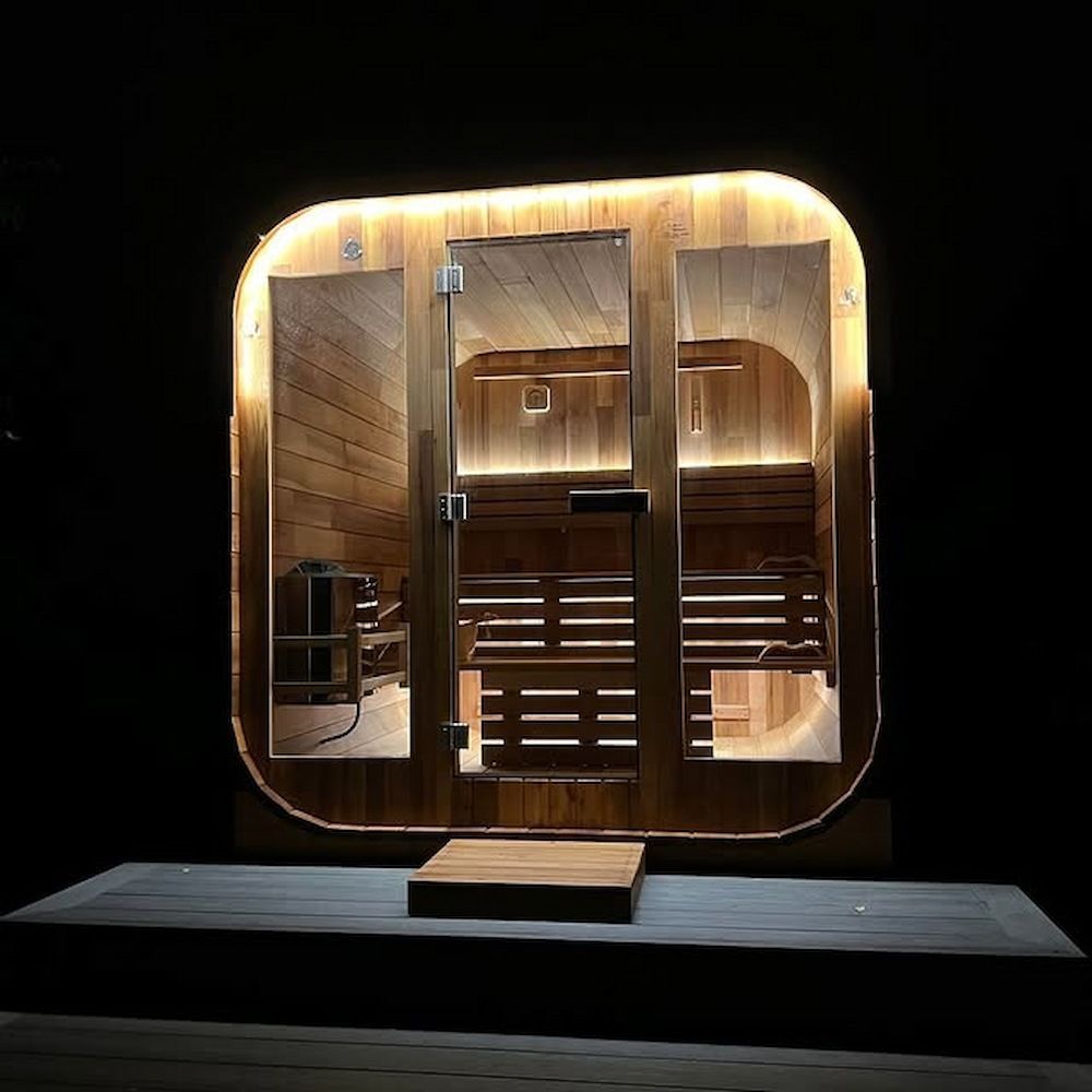 A Wooden Sauna is Lit Up at Night — Mylec Electrical Solutions in North Wollongong, NSW
