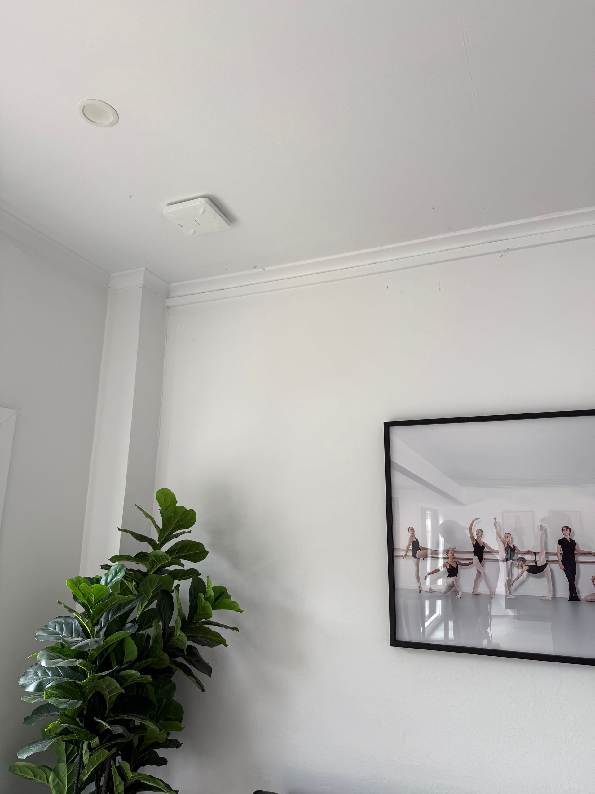 A Person is Fixing a Smoke Detector With a Screwdriver — Mylec Electrical Solutions in North Wollongong, NSW