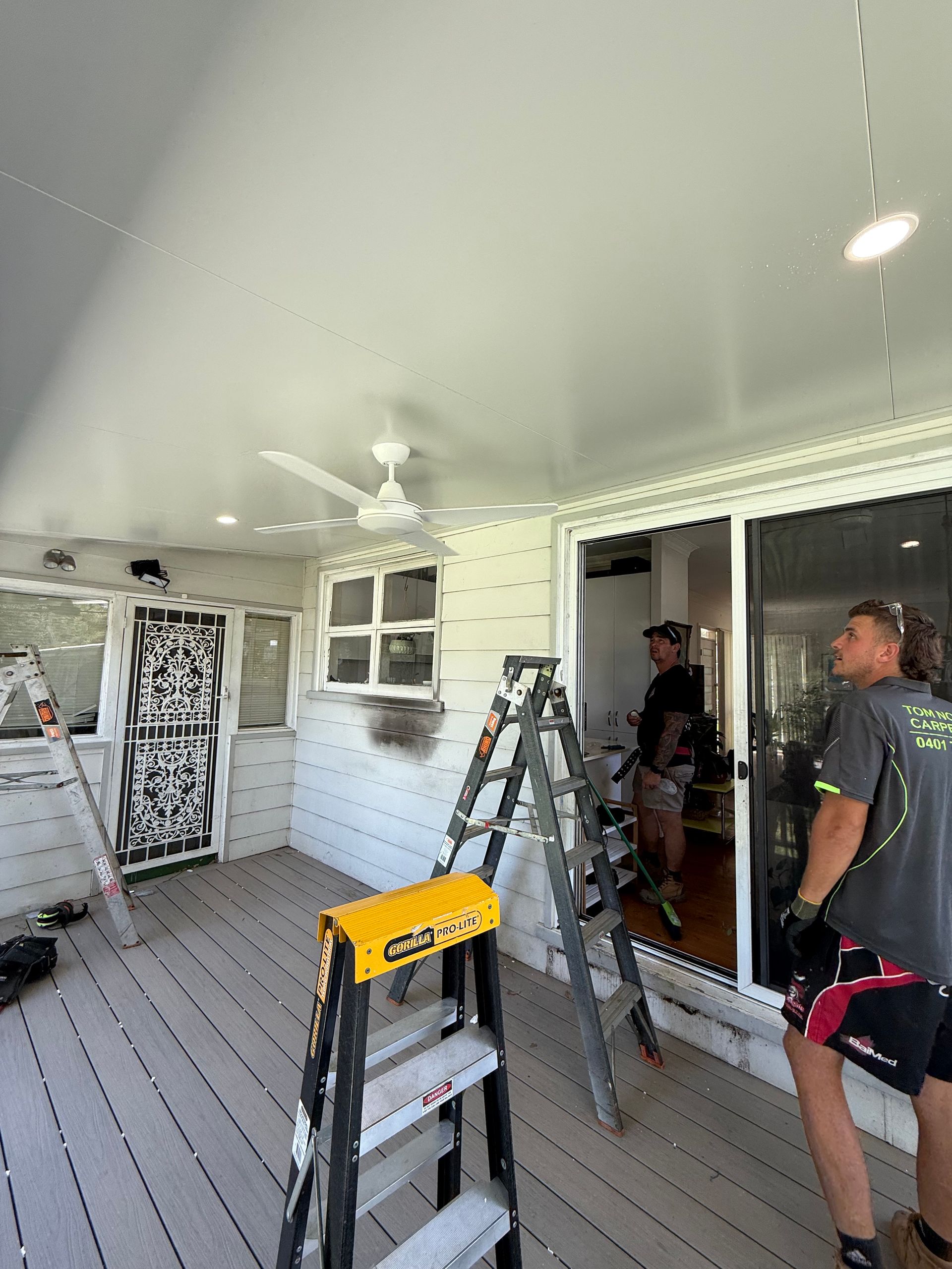 A staircase with a window and candles hanging from the ceiling — Mylec Electrical Solutions in Shell Cove, NSW