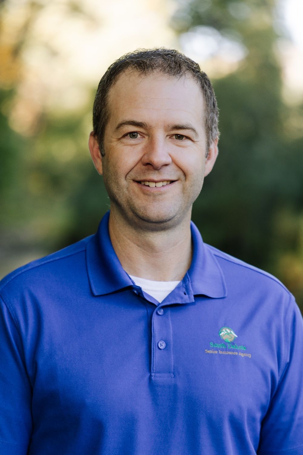 Brian Spire is smiling for the camera.