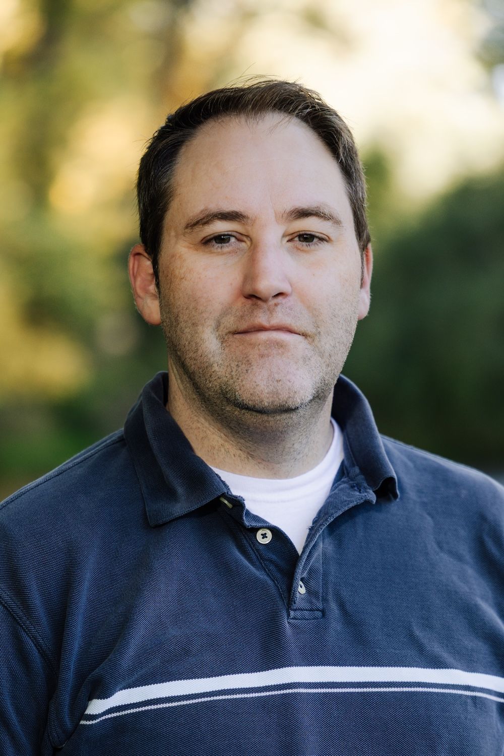 Assistant Jason is smiling for the camera.