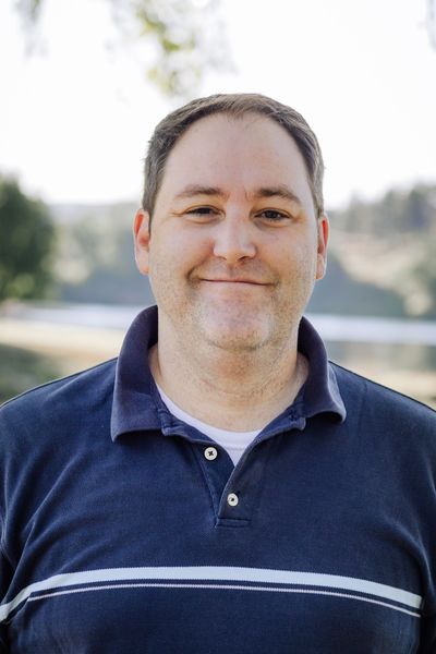 Assistant Jason is smiling for the camera.