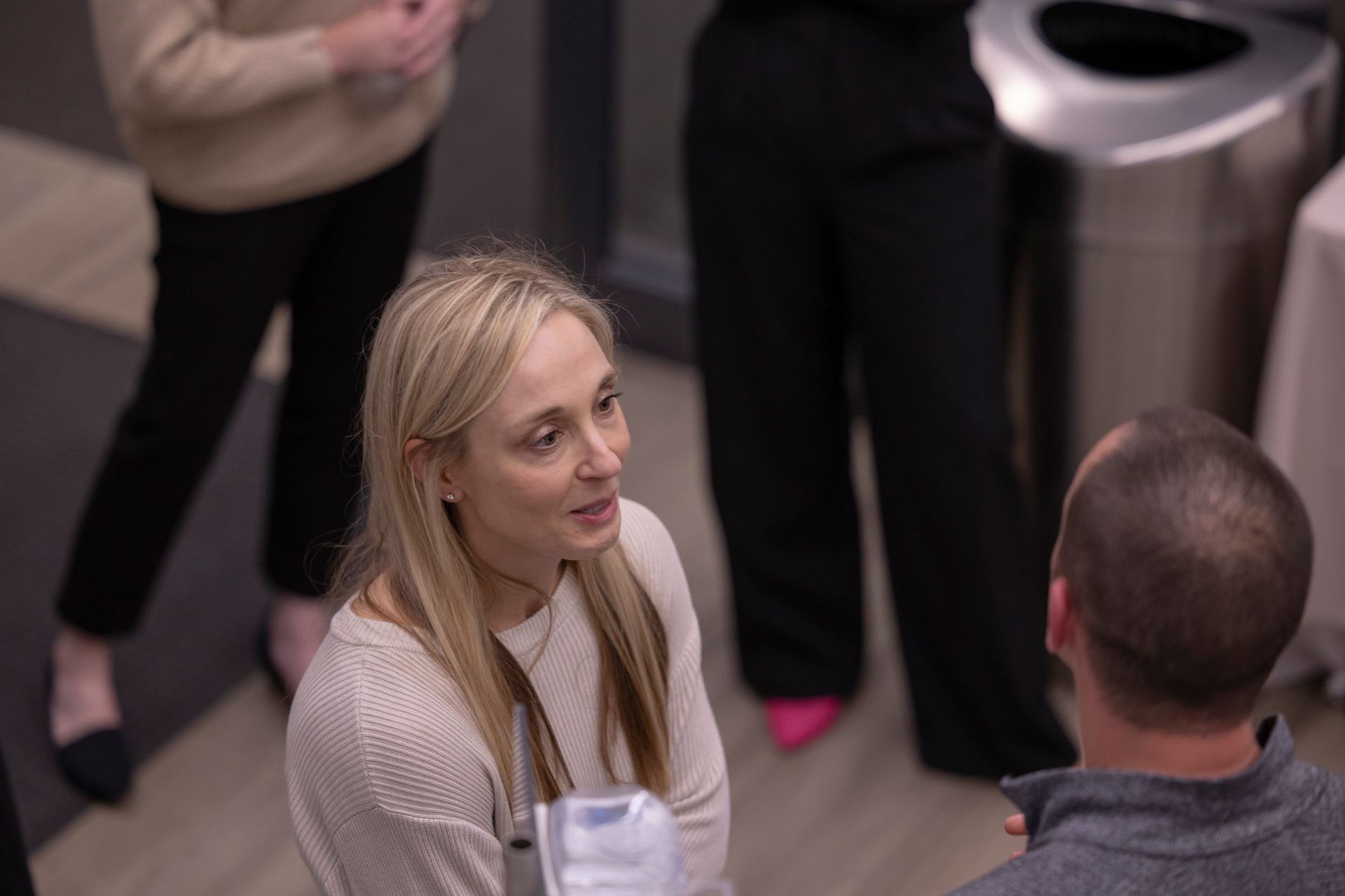 A man and a woman are talking to each other in a room.