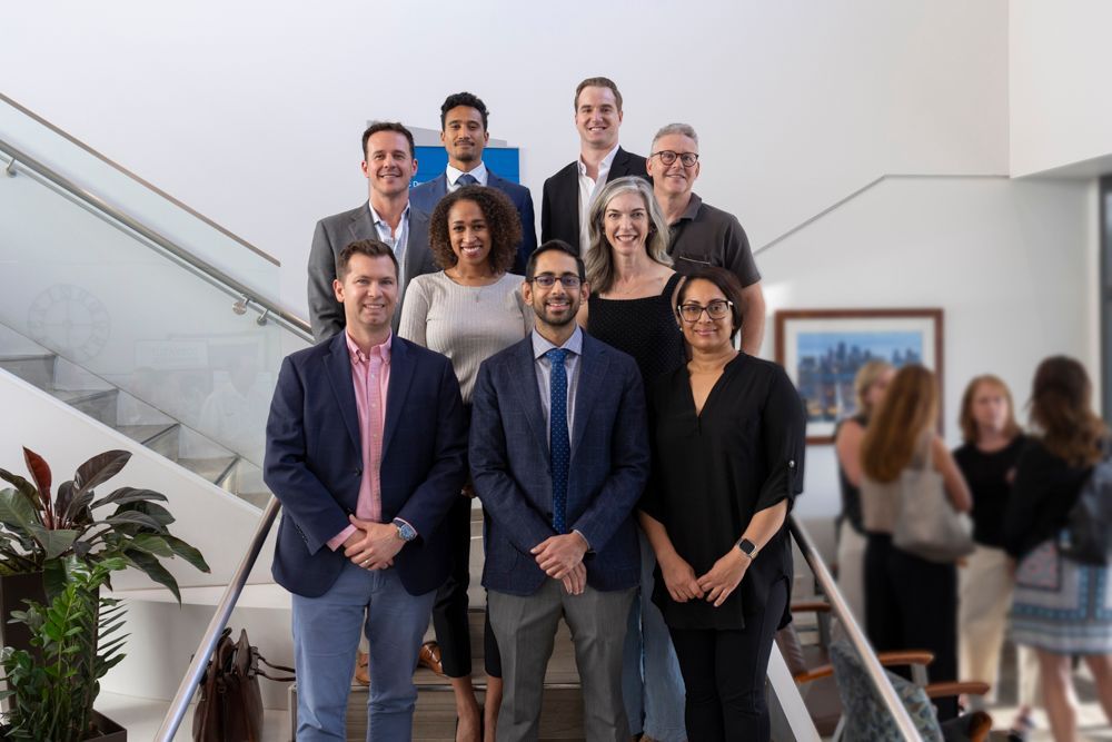 A group of people are posing for a picture on a set of stairs.