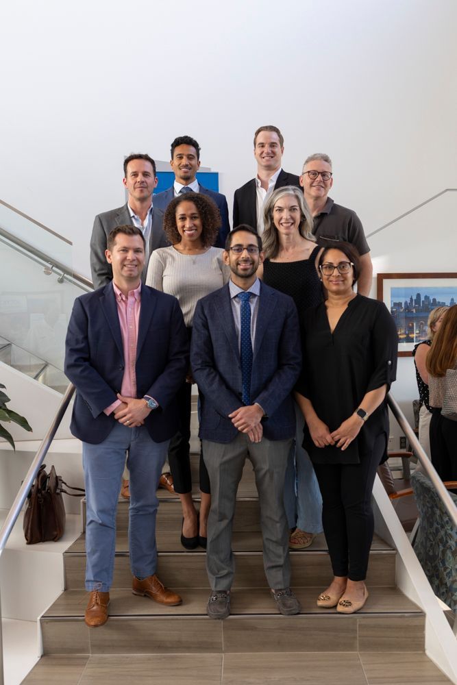 A group of people are posing for a picture on a set of stairs.