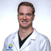 A man in a white lab coat is smiling for the camera.