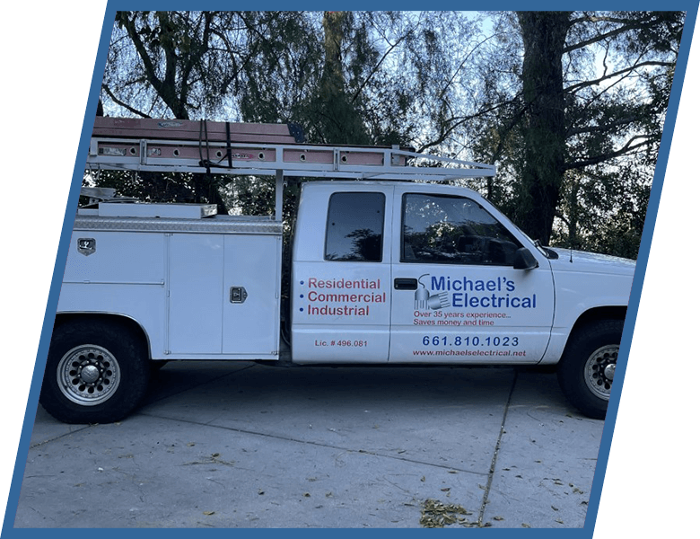 A white michael 's electrical truck is parked in a driveway